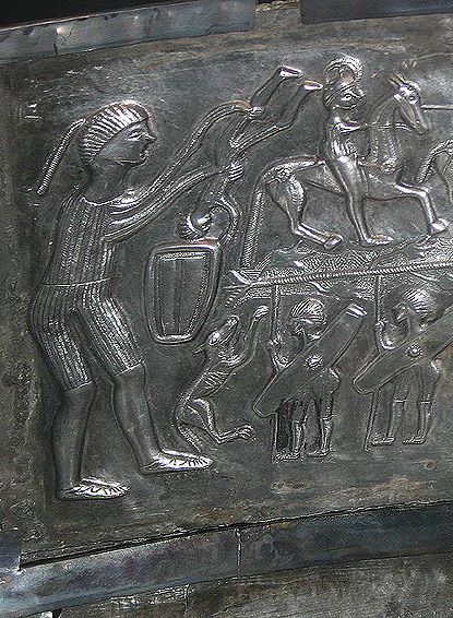 Interior panel from the late Iron Age Gundestrup cauldron depicting a giant warrior rejuvenating soldiers in some kind of vessel, making them into mounted  knights.