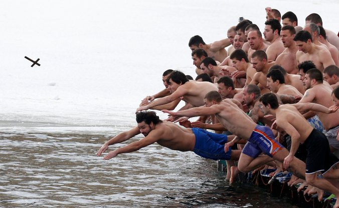 Bulgarian men 'diving for the cross' at Epiphany. Photo: Stoyan Nenov/Reuters