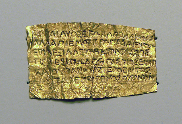 A 4thC BCE 'Orphic' gold tablet. The reflectivity of the tablet is broken up by the inscription....