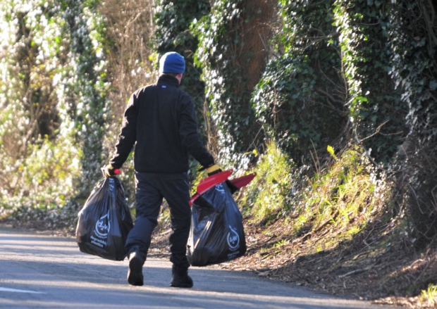 ‘I’ve driven past it often, and thought that for a while now it was getting out of hand,’ he said, while climbing on to the bridge and removing a bike helmet from a high branch. ‘I had a day off today, so I thought I’d just come down now and do it quickly.’ Really?