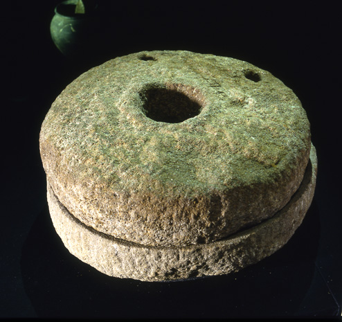 A set of 'quern' stones in a Viking era hand-mill. The grains were poured into the 'eye' of the mill and the stones rotated with a stick. Like the hearth of a house, the mill would have been associated with magical potency. 